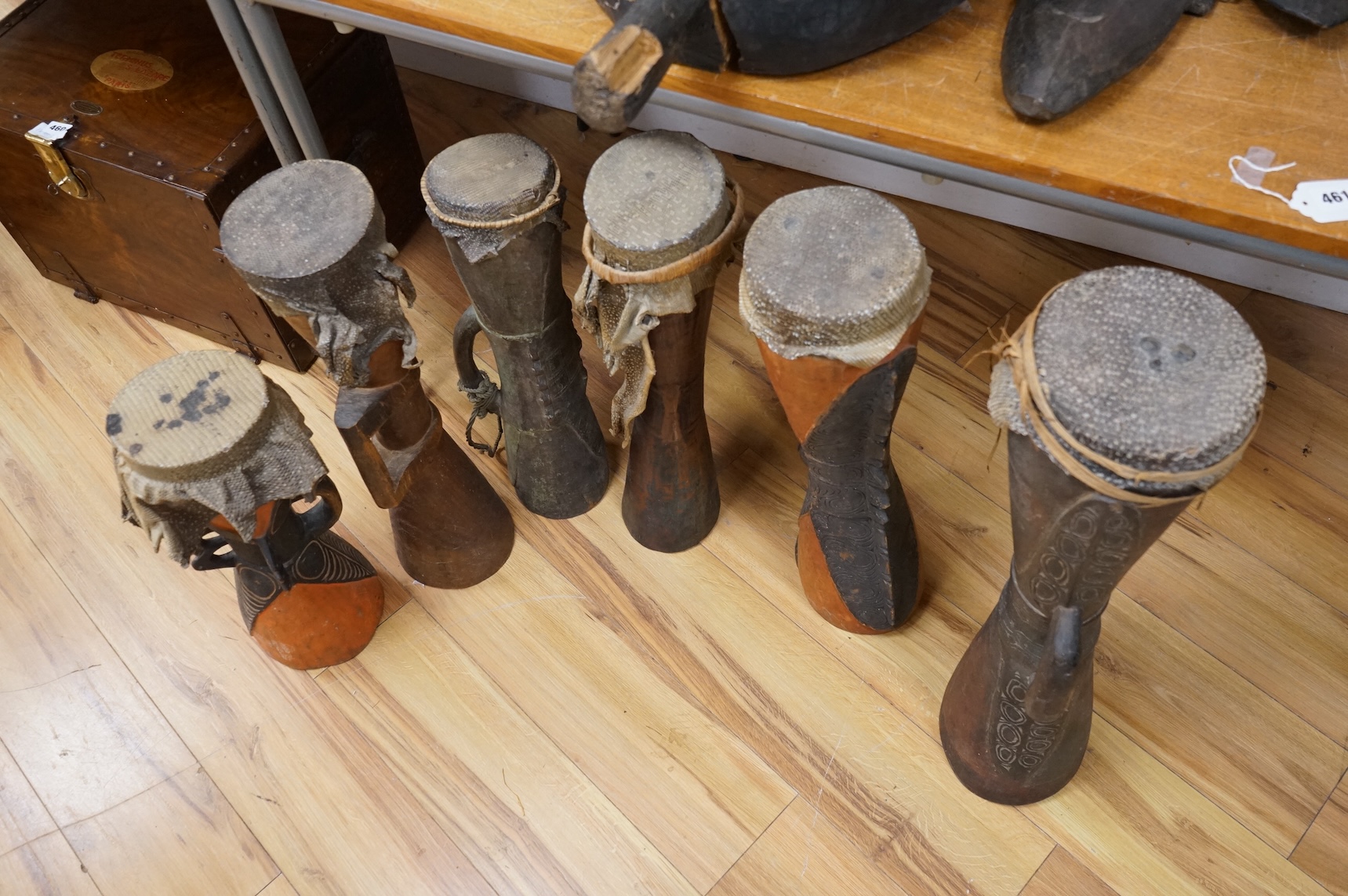 Six Papua New Guinea Sepik River Kundu wooden hand drums, of typical hour-glass form with skin tops, variously carved and incised with two painted, tallest 70cm